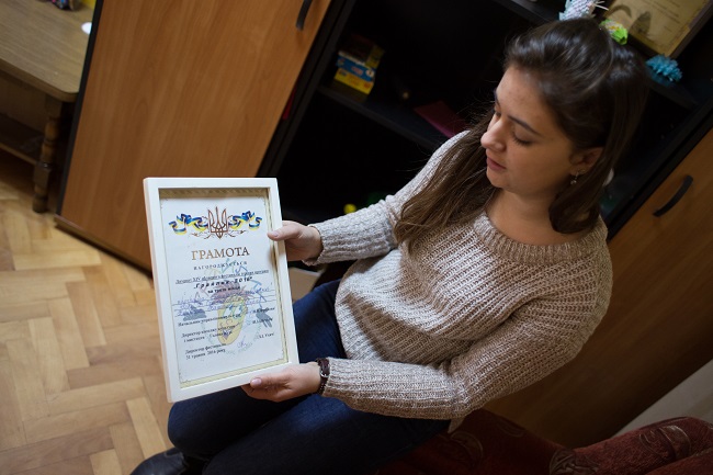 Наталя показує грамоту за третє місце в обласному фестивалі ігрових програм 